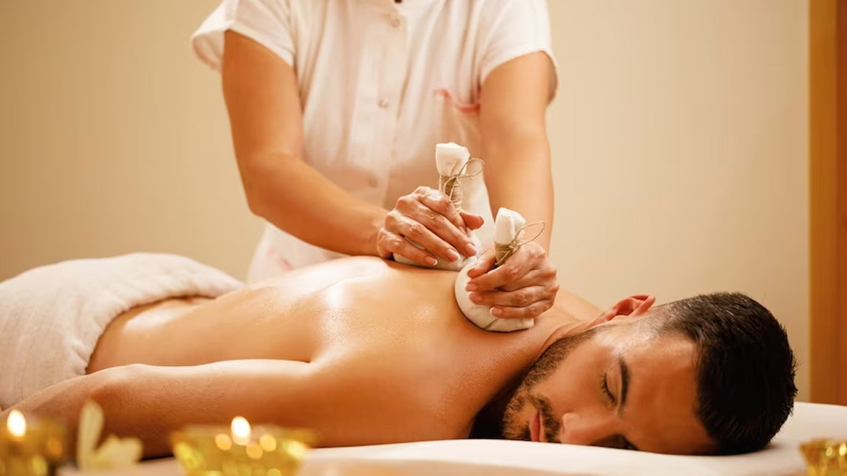 Professional Herbal Potli Massage treatment with essential oils in serene spa environment